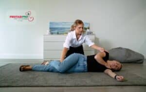 First aid responder placing person in recovery position