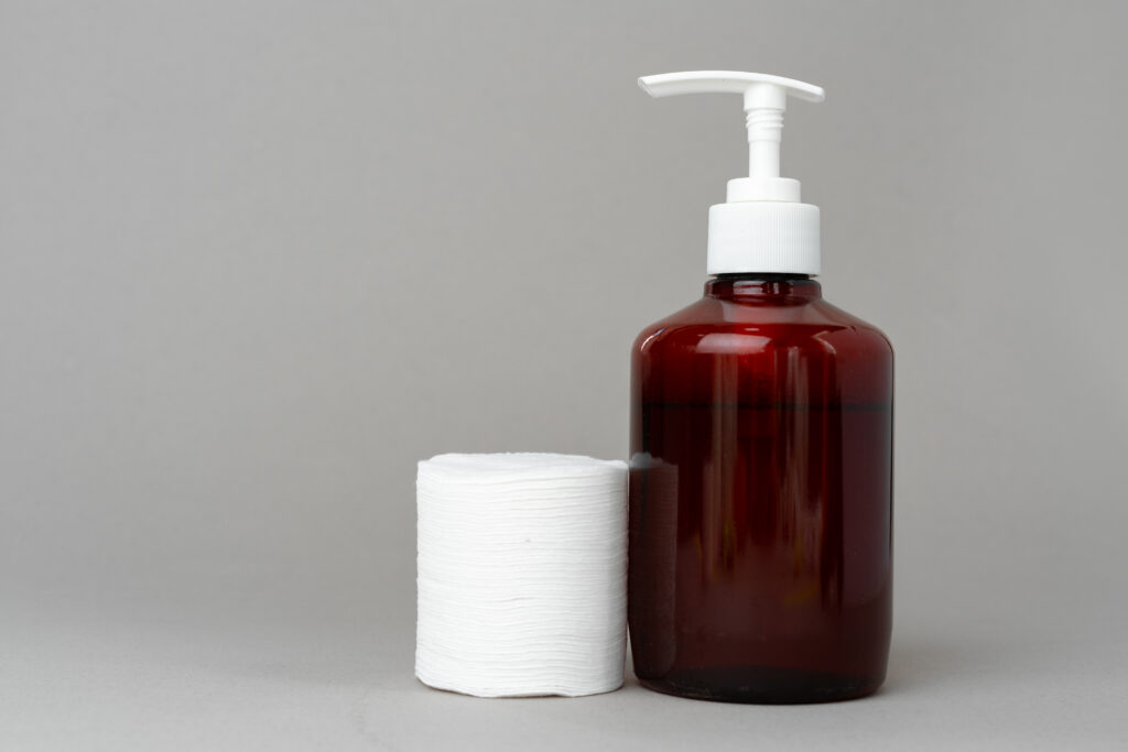 Stack of cotton discs and antiseptic bottle