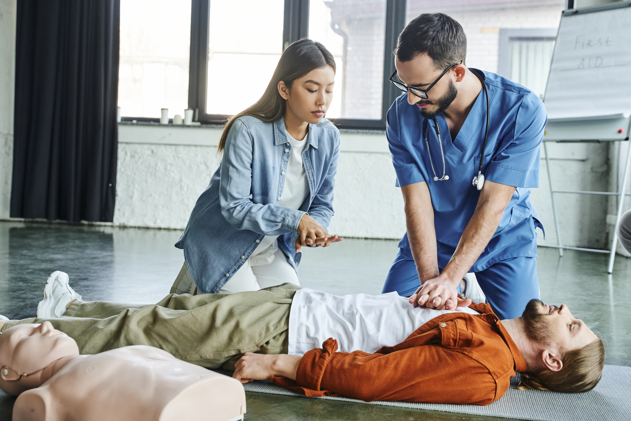 medical seminar, healthcare worker in uniform and eyeglasses showing to asian woman cardiopulmonary