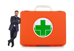 Young business man leaning against near a comprehensive first aid kit