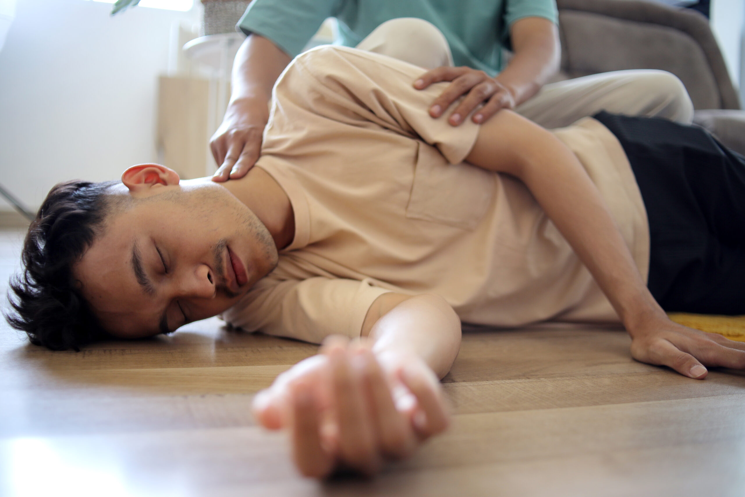 man-doing-cpr-first-aid-checking-pulse-to-asian