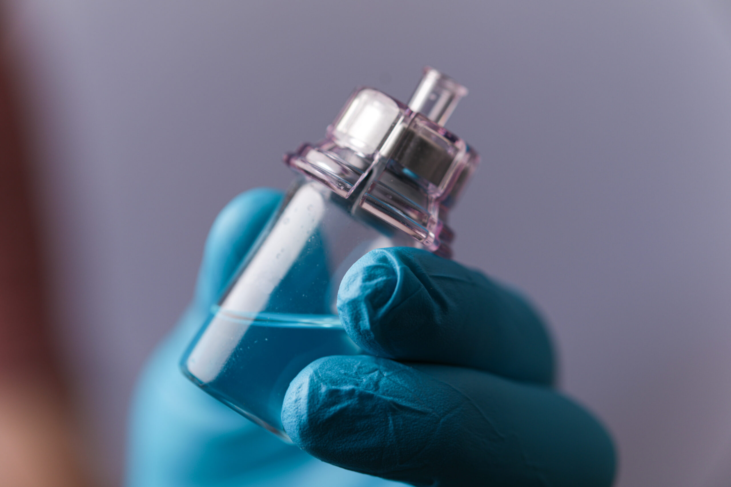 A medical professional's hand holding a vaccine