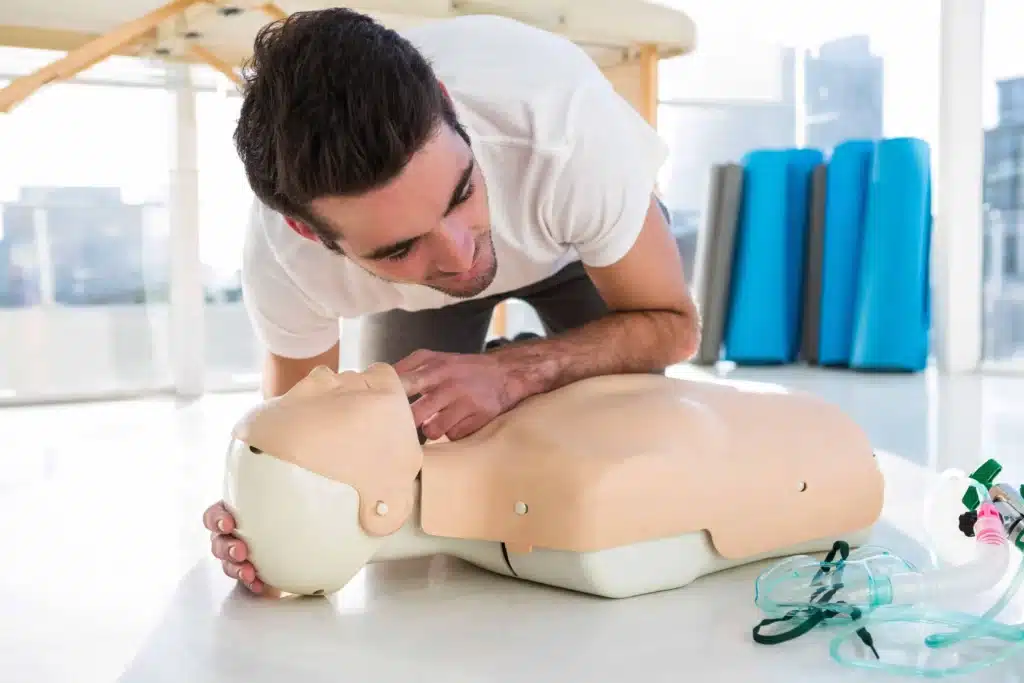 Trainer showing rescue breathing on manikin Sydney