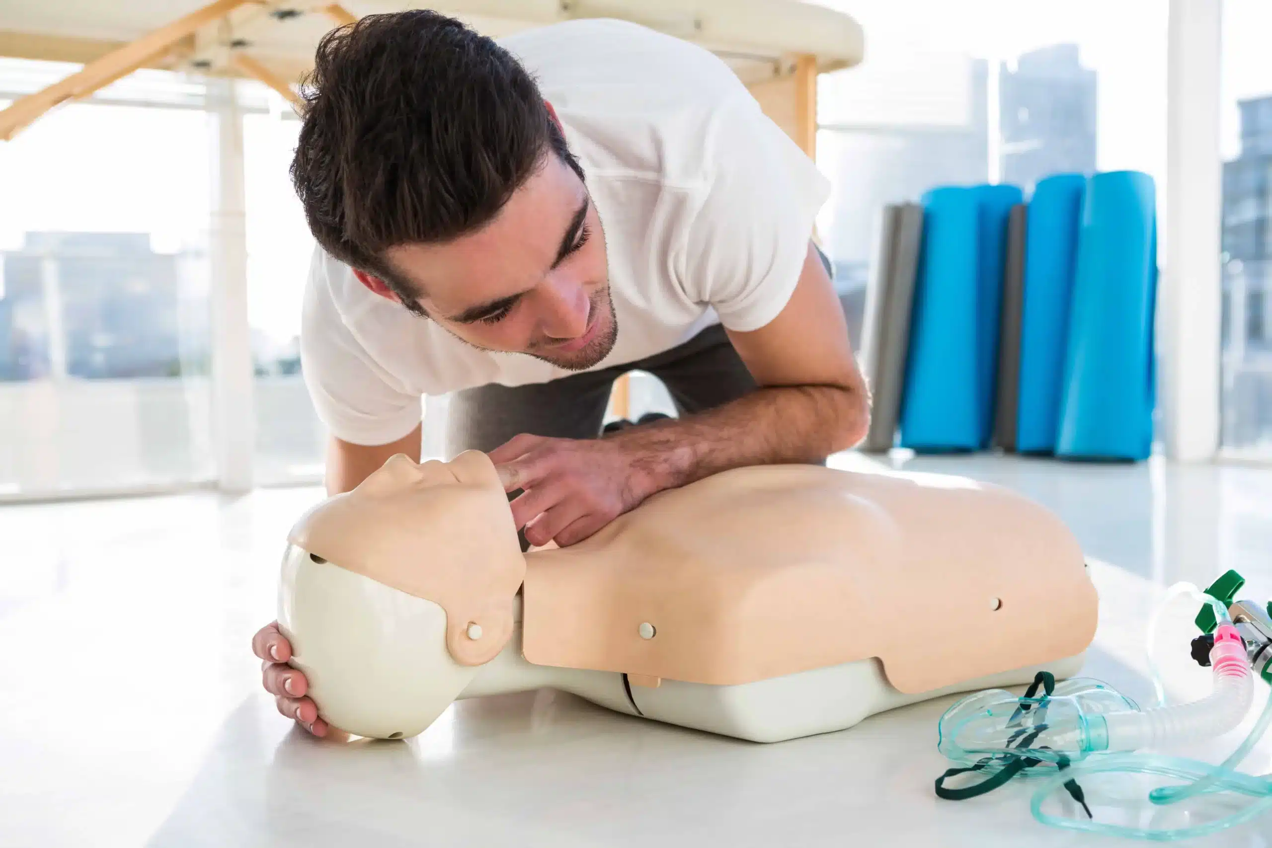 Trainer showing rescue breathing on manikin Sydney