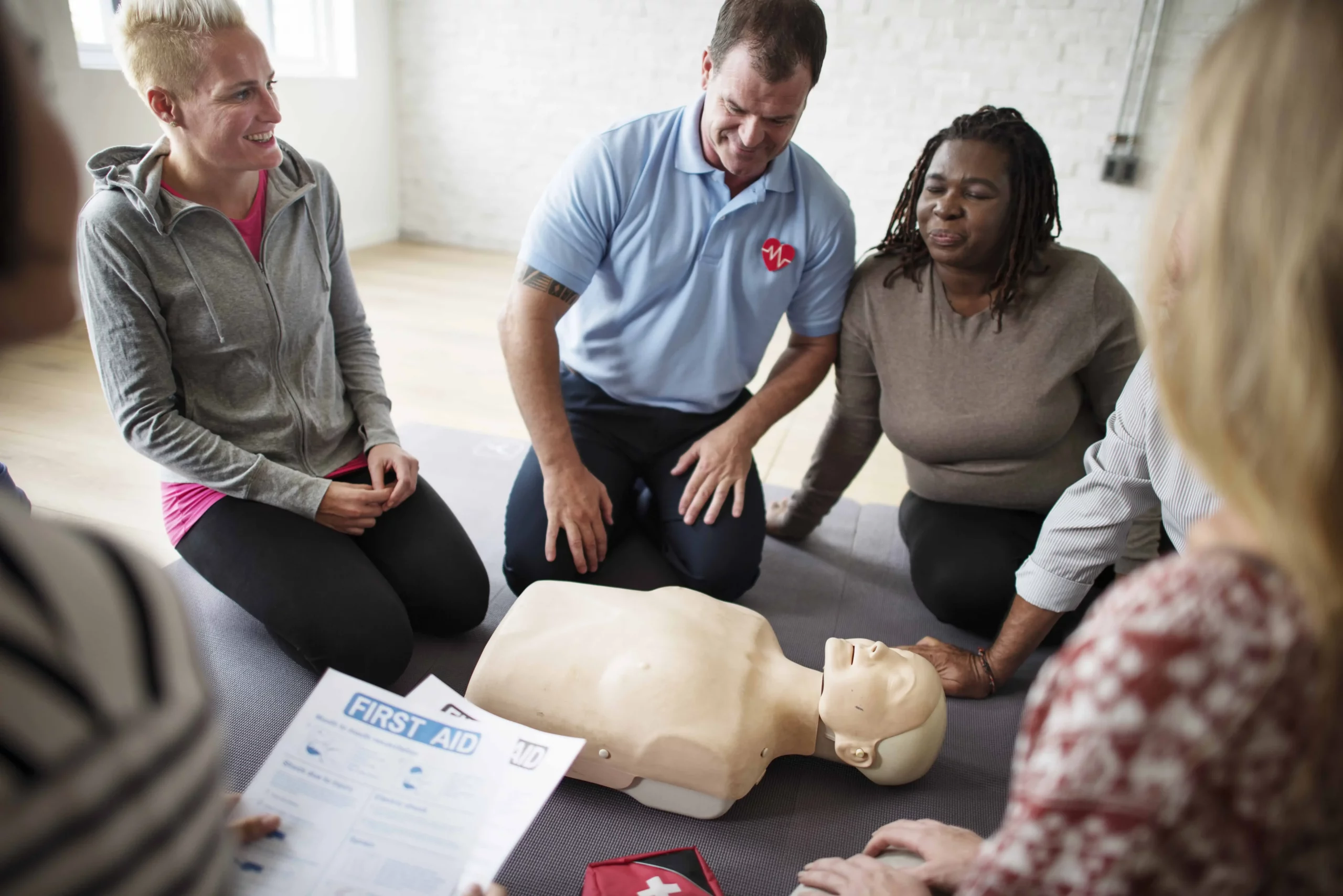 Group in Perth practicing CPR techniques with instructor supervision