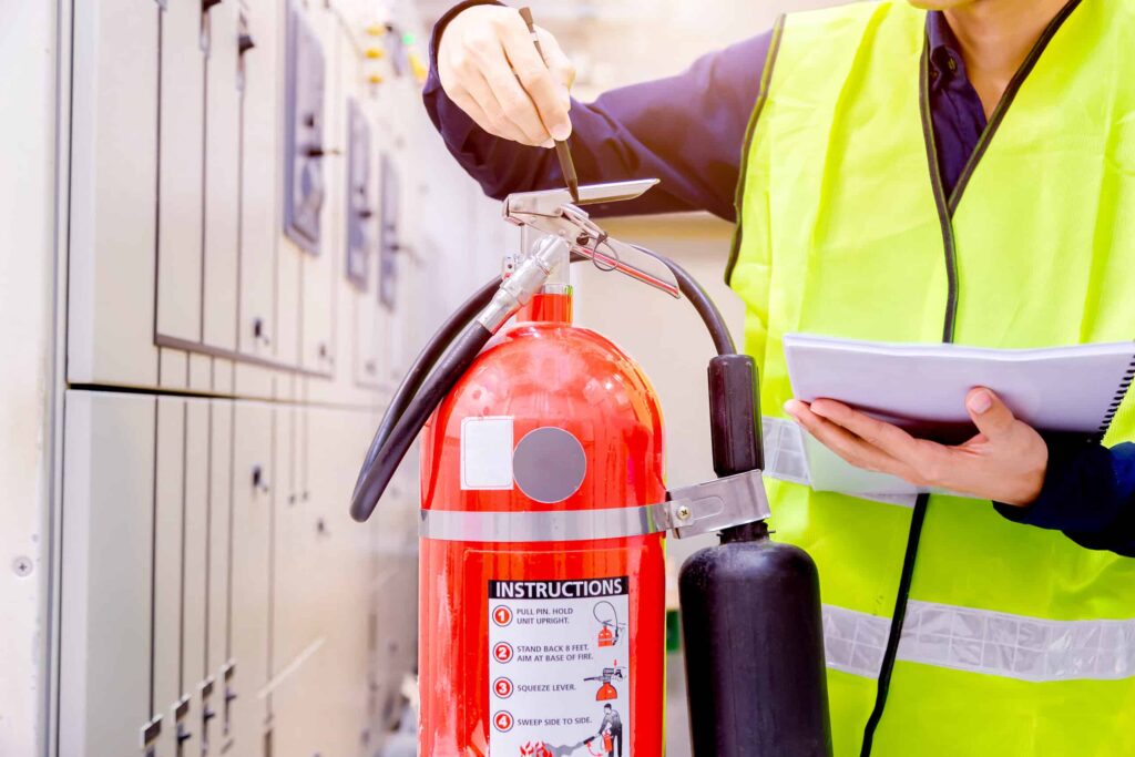 fire warden checking fire extinguisher