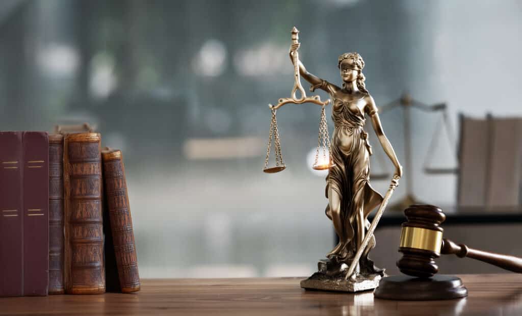 legal scene - desk, books, lady justice statue